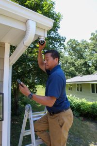 Image of Protection Systems Inc installing an outside camera as part of nc video surveillance security